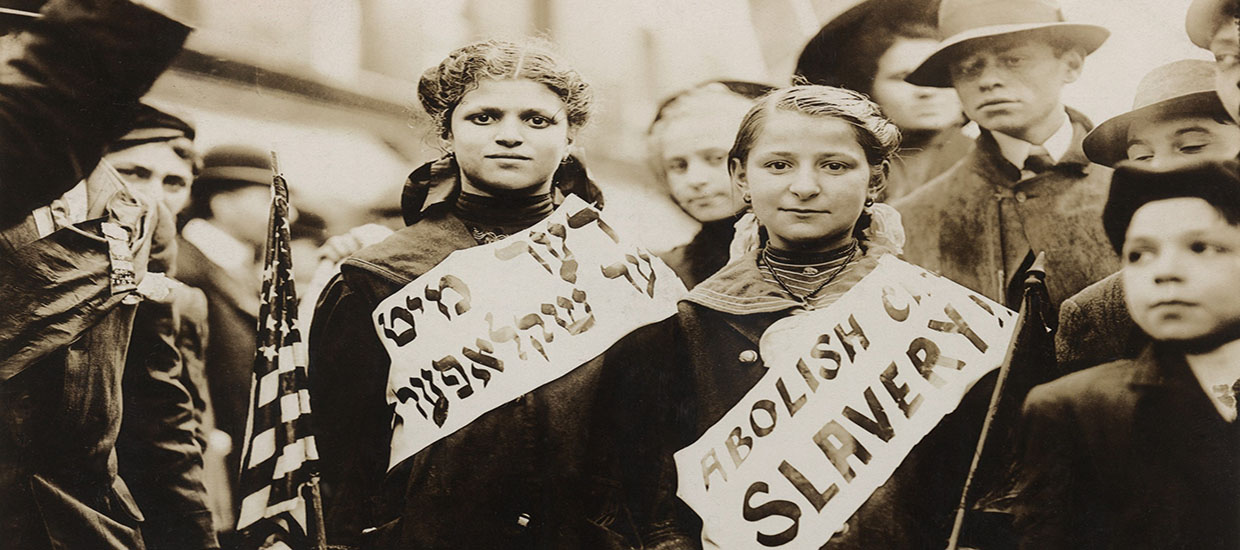 This is a stock photo. Jewish citizens in American holding signs in English and Yiddish advocating for the abolition of slavery.