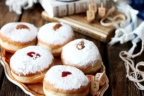 This is a stock photo. Traditional Jewish donuts filled with jam.