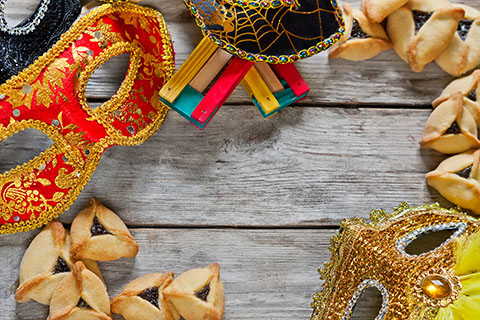 This is a stock photo. An overhead view of a table setting for the Purim holiday.