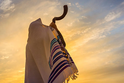 This is a stock photo. A man blowing the Shofar horn. 